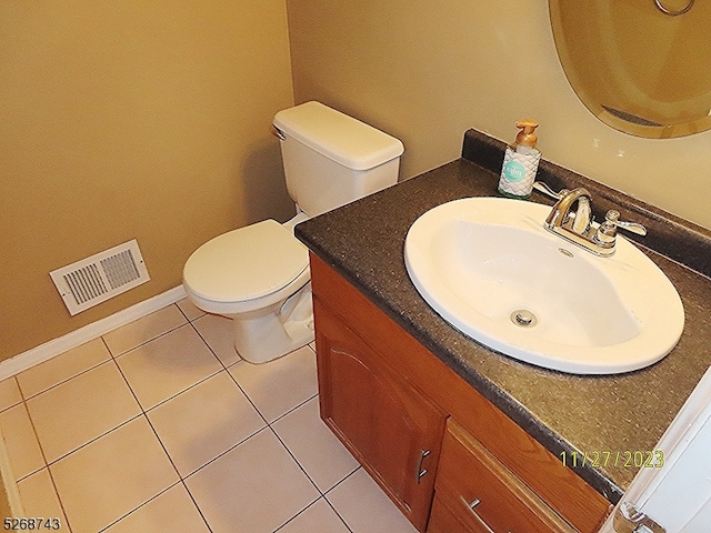 bathroom featuring tile patterned floors, vanity, and toilet