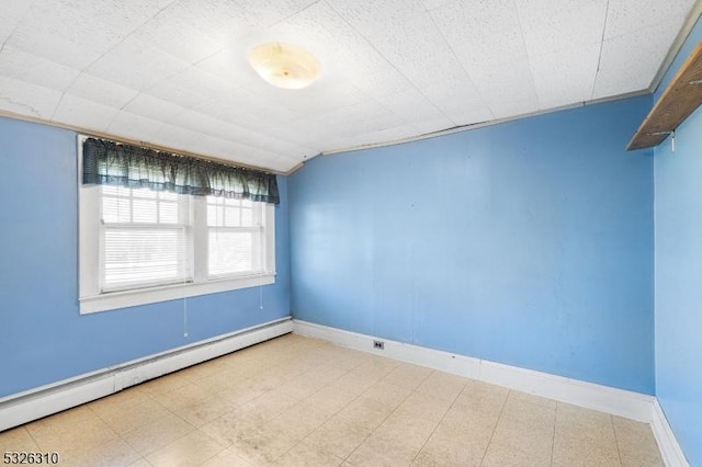 unfurnished room with vaulted ceiling and a baseboard heating unit