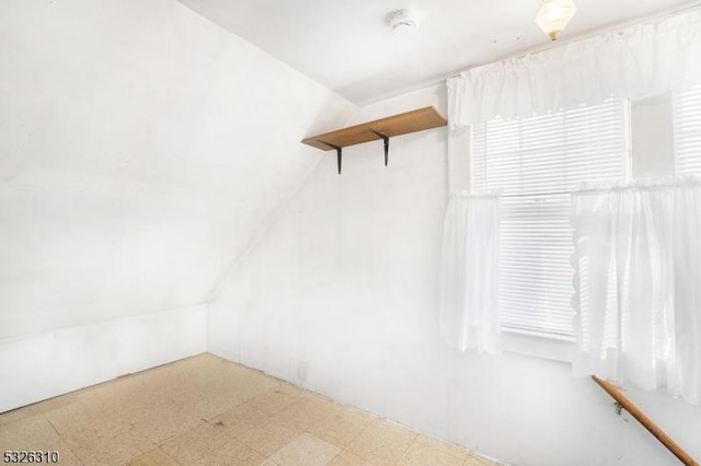 walk in closet with vaulted ceiling