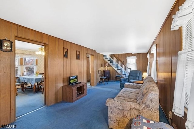 living room with wooden walls and carpet