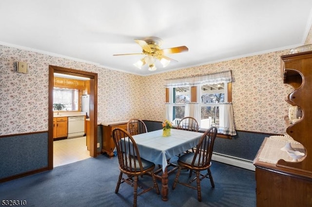 dining area with baseboard heating, ceiling fan, carpet flooring, and ornamental molding