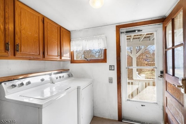 laundry room featuring cabinets and washing machine and clothes dryer