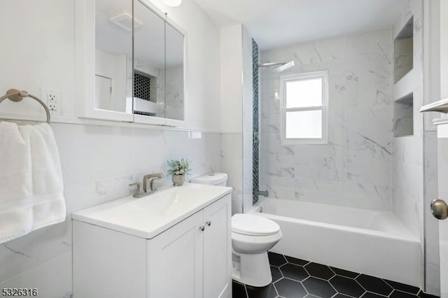 full bathroom with toilet, vanity, tile walls, shower / washtub combination, and tasteful backsplash