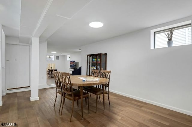 dining room featuring baseboards and wood finished floors