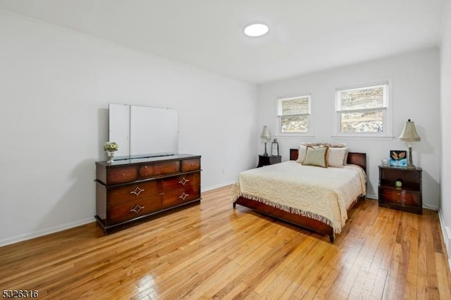 bedroom with baseboards and light wood-style floors