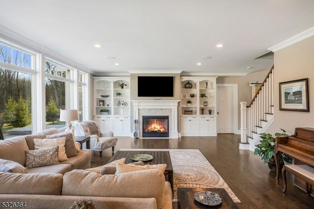 living room with a wealth of natural light, crown molding, and dark hardwood / wood-style floors