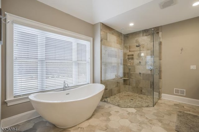 bathroom featuring separate shower and tub