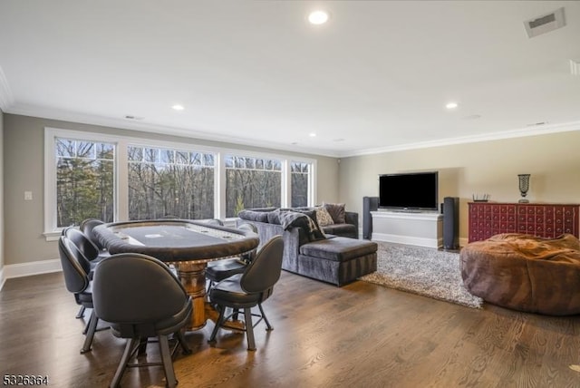 dining area featuring crown molding and dark wood-type flooring