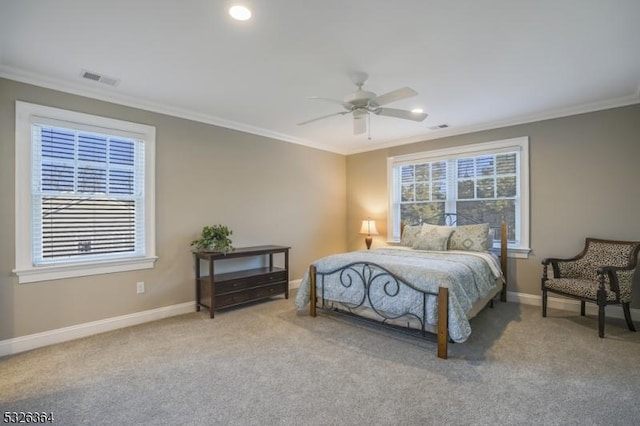 carpeted bedroom with ceiling fan and crown molding