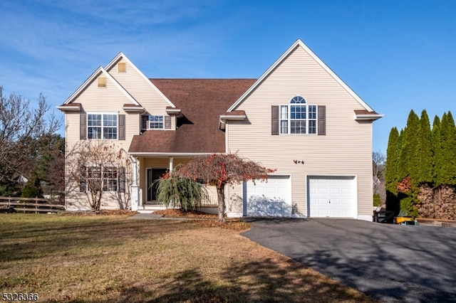 view of front property with a garage and a front lawn