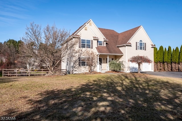 view of front facade featuring a front yard and a garage