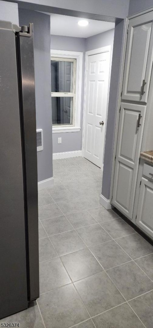 hall with light tile patterned flooring