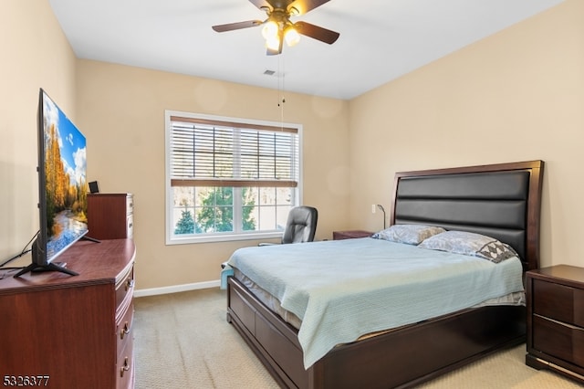 bedroom with light colored carpet and ceiling fan