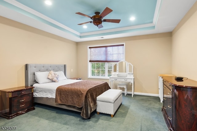 carpeted bedroom featuring ceiling fan, a raised ceiling, and ornamental molding