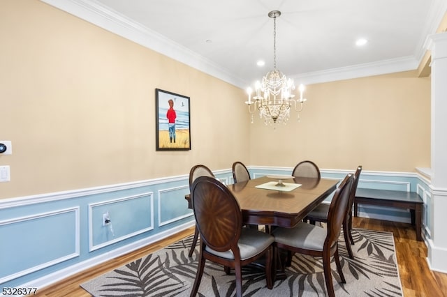 dining room with a chandelier, dark hardwood / wood-style floors, and ornamental molding