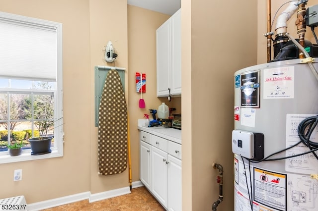 kitchen featuring white cabinets and water heater