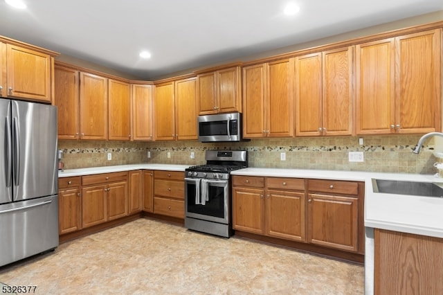 kitchen featuring tasteful backsplash, sink, and stainless steel appliances