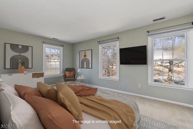 carpeted living room featuring baseboards and visible vents