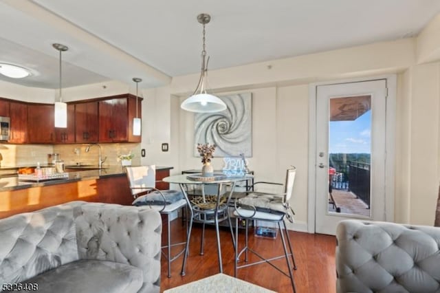 dining area with sink and dark hardwood / wood-style floors