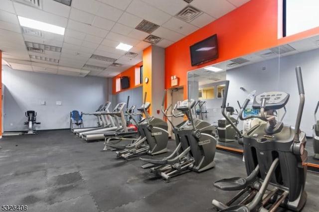 workout area featuring a paneled ceiling