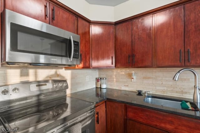 kitchen with backsplash, sink, and stainless steel appliances