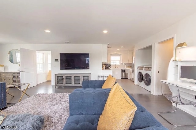 living room with plenty of natural light, separate washer and dryer, and sink