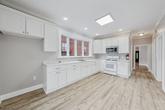 kitchen with sink, white range oven, light wood-type flooring, white cabinets, and ornamental molding