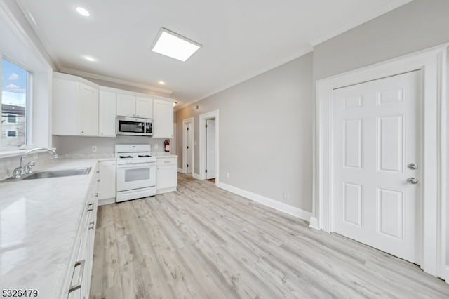 kitchen featuring white stove, white cabinets, sink, light stone countertops, and light wood-type flooring