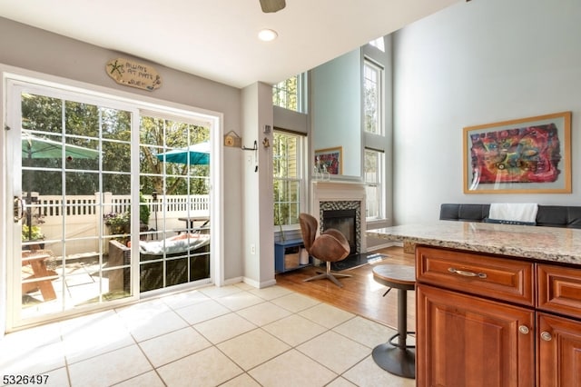 entryway featuring ceiling fan and light tile patterned flooring