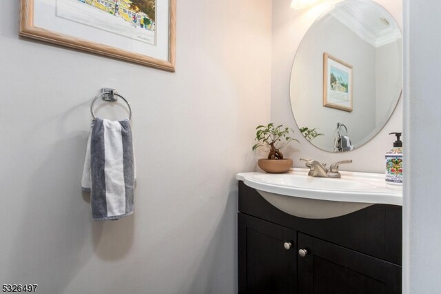 bathroom featuring vanity and ornamental molding