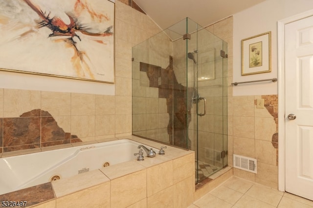 bathroom featuring vaulted ceiling, tile walls, tile patterned floors, and shower with separate bathtub