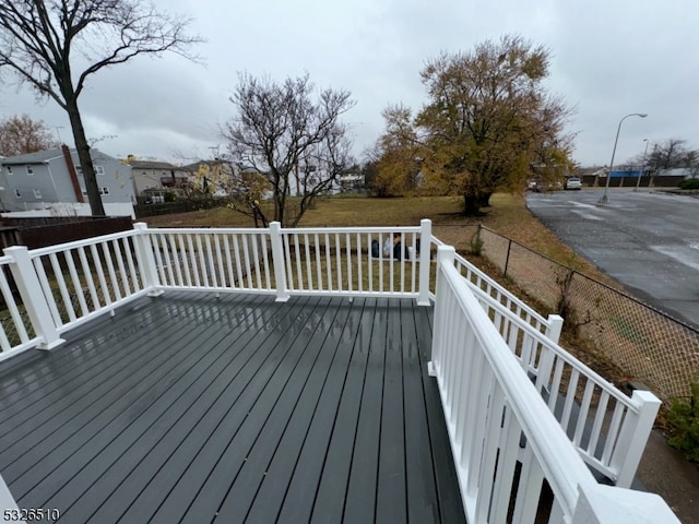 wooden deck with a lawn