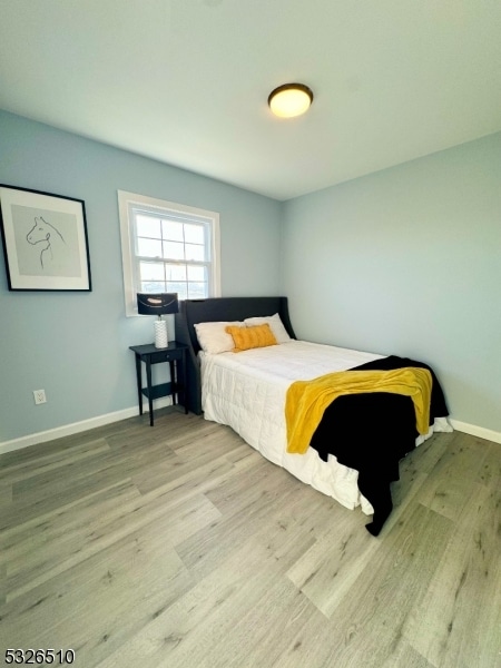 bedroom with light hardwood / wood-style floors