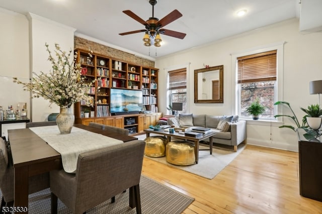 interior space featuring light hardwood / wood-style floors, ceiling fan, and crown molding