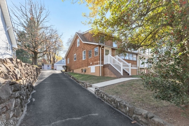 view of home's exterior with a garage and an outdoor structure