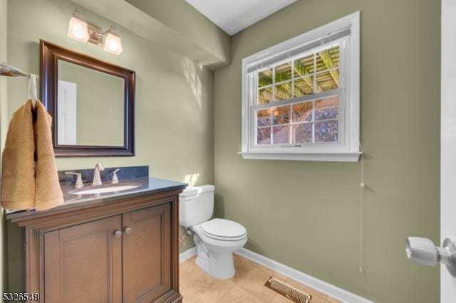 bathroom with tile patterned floors, vanity, and toilet