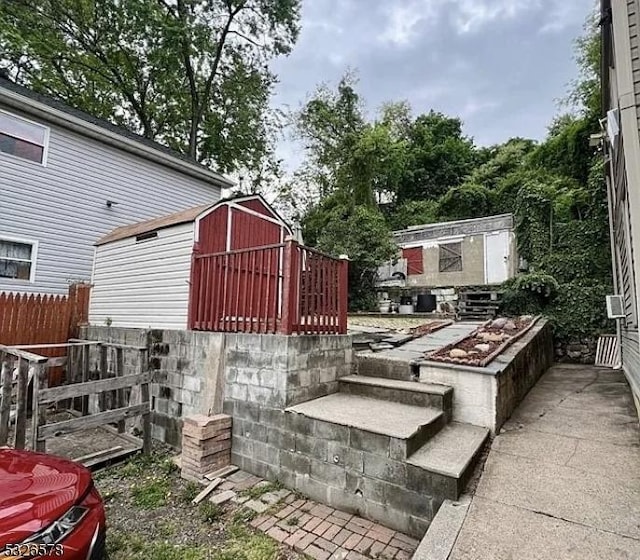 view of patio featuring a storage unit