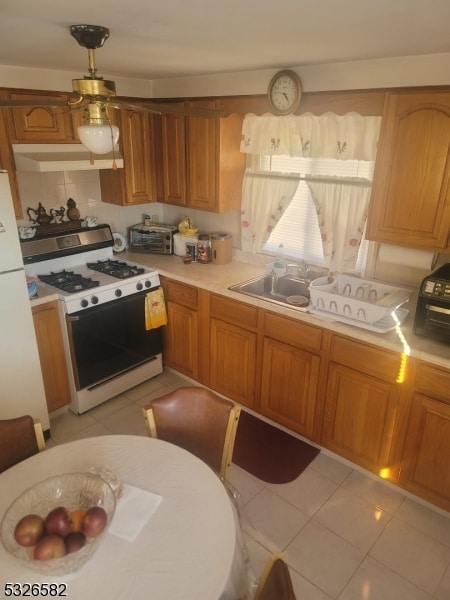 kitchen with white appliances and light tile patterned floors