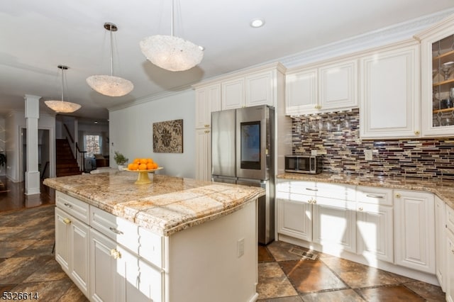 kitchen featuring stainless steel refrigerator, crown molding, a kitchen island, and pendant lighting