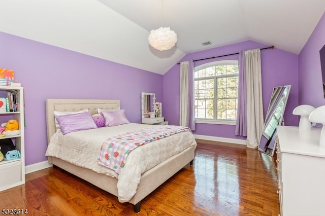 bedroom featuring dark hardwood / wood-style floors and vaulted ceiling