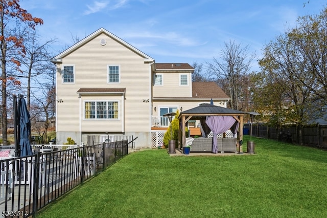 rear view of property featuring a gazebo, a yard, and an outdoor hangout area