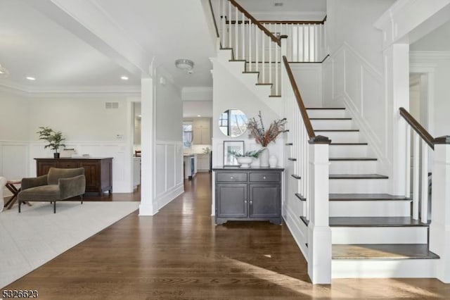 staircase featuring hardwood / wood-style flooring and ornamental molding