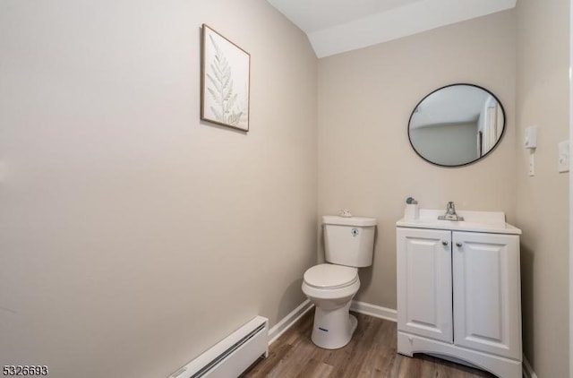 bathroom featuring a baseboard radiator, hardwood / wood-style floors, vaulted ceiling, toilet, and vanity