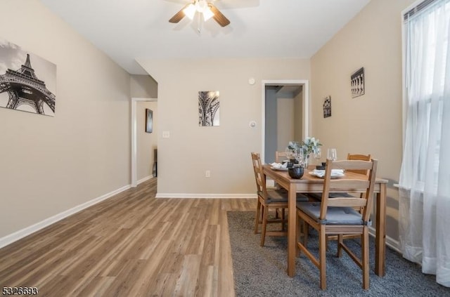 dining area featuring hardwood / wood-style flooring and ceiling fan