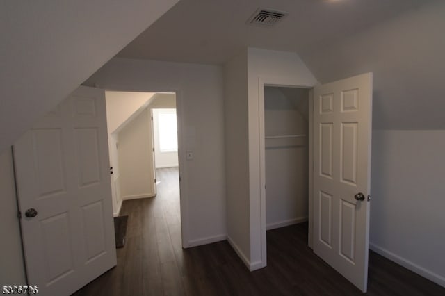 bonus room featuring lofted ceiling and dark wood-type flooring