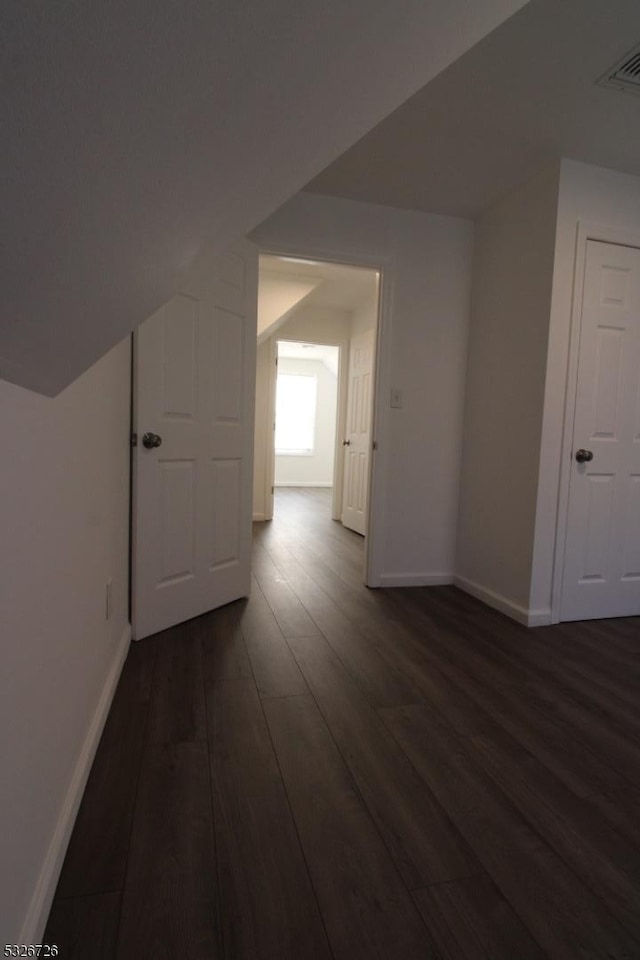 additional living space with dark wood-type flooring