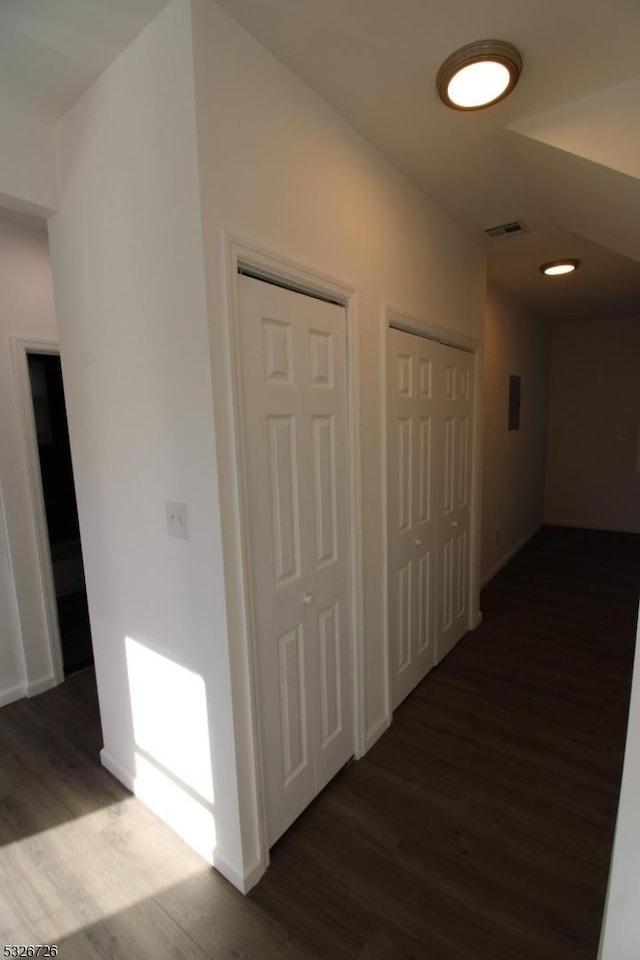 hallway featuring dark hardwood / wood-style flooring