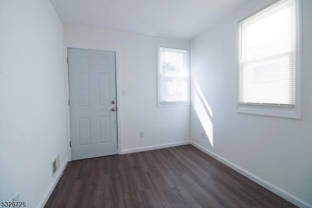 empty room with dark hardwood / wood-style floors