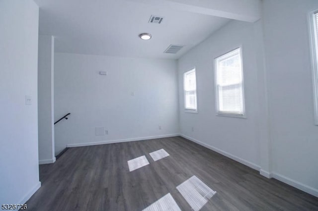 empty room with dark wood-type flooring