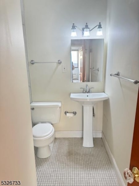 bathroom featuring tile patterned floors and toilet